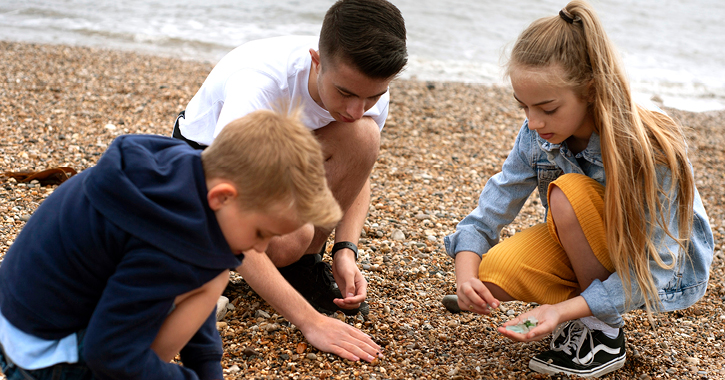 group of children collecting sea glass on Seaham Beach